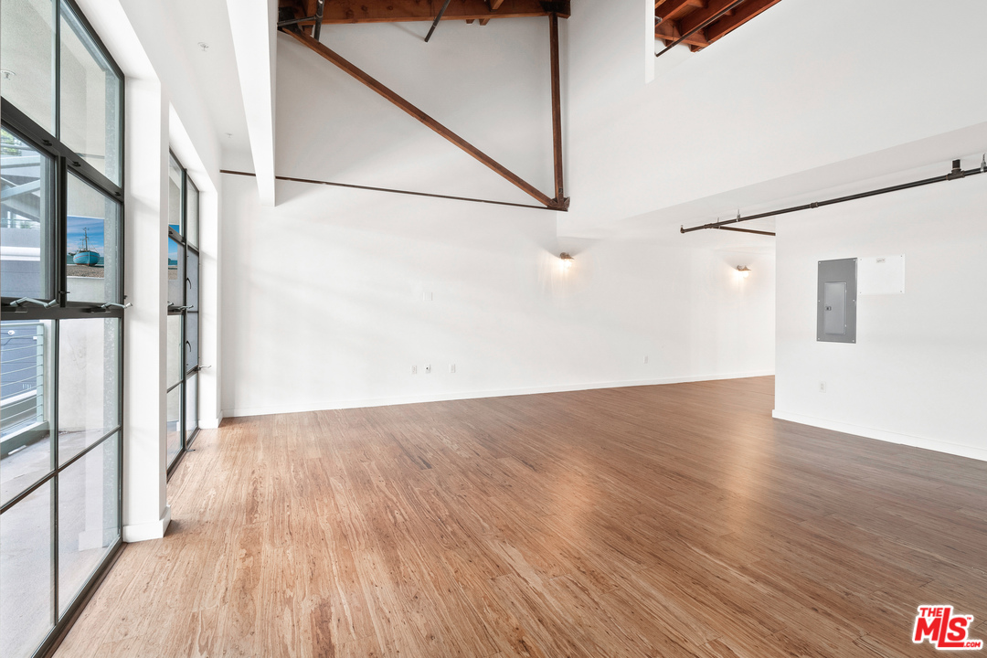 1046 Princeton Drive, Unit 210 Venice, CA 90292 - Photo 16 of 37 a view of a big room with wooden floor and windows