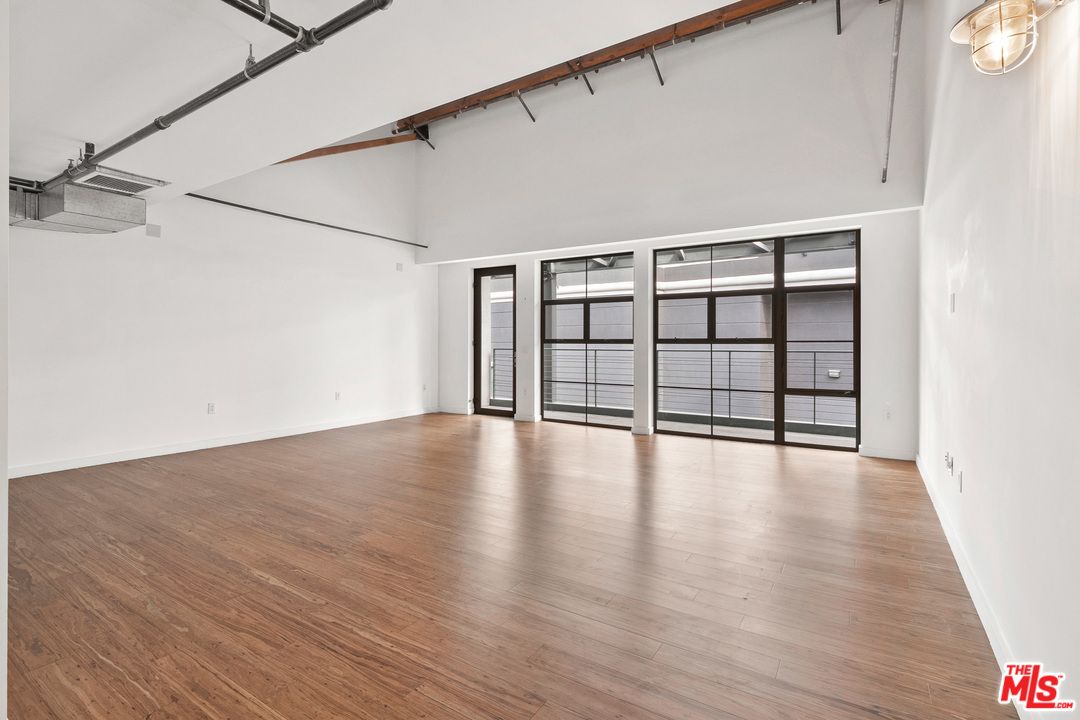 1046 Princeton Drive, Unit 210 Venice, CA 90292 - Photo 17 of 37 a view of an empty room with wooden floor and a window