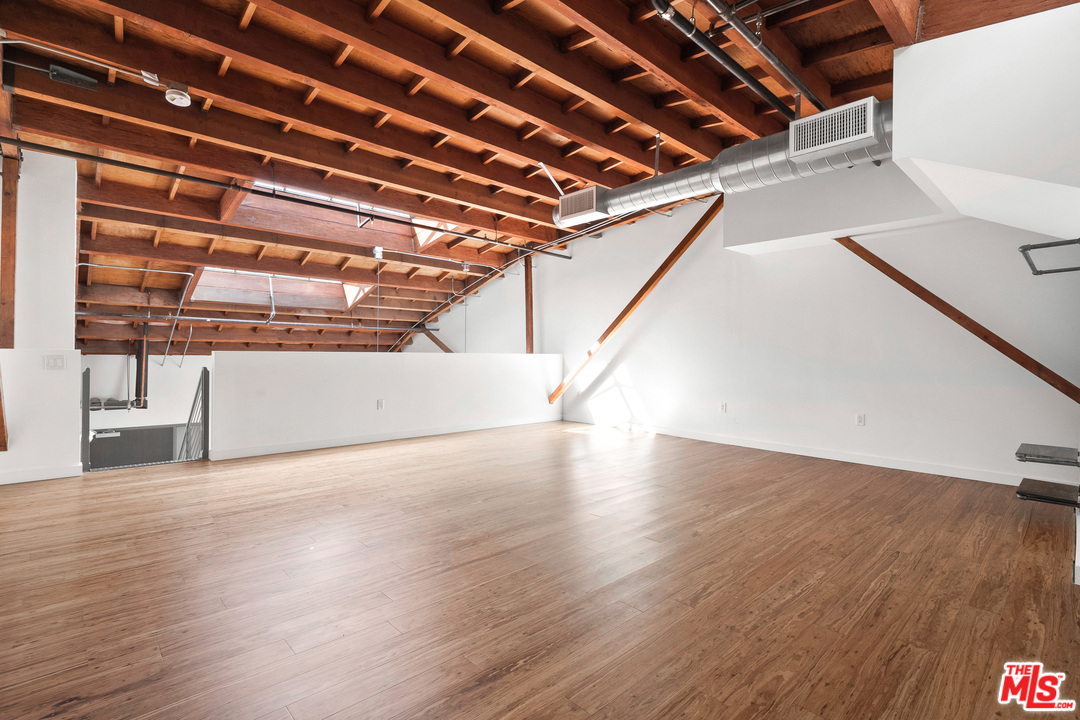 1046 Princeton Drive, Unit 210 Venice, CA 90292 - Photo 19 of 37 a view of an empty room with wooden floor