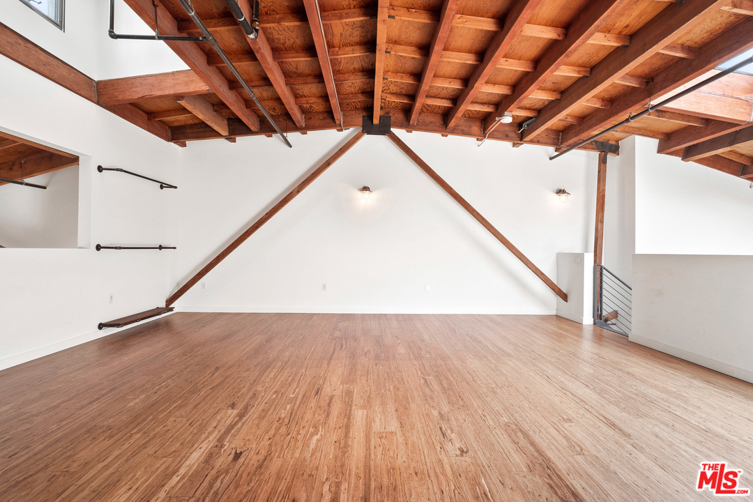 1046 Princeton Drive, Unit 210 Venice, CA 90292 - Photo 20 of 37 a view of an empty room with wooden floor