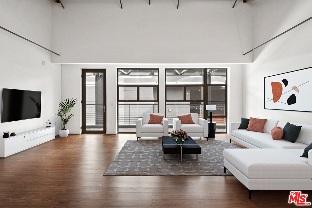 1046 Princeton Drive, Unit 210 Venice, CA 90292 - Photo 3 of 37 a living room with furniture large window and a flat screen tv
