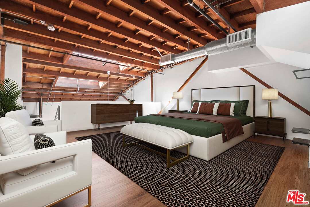 1046 Princeton Drive, Unit 210 Venice, CA 90292 - Photo 4 of 37 a bedroom with furniture and a chandelier