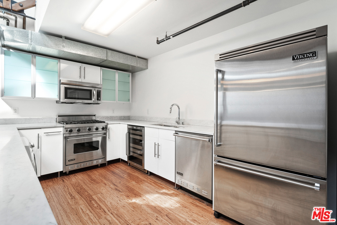 1046 Princeton Drive, Unit 210 Venice, CA 90292 - Photo 10 of 37 a kitchen with cabinets stainless steel appliances and a counter space