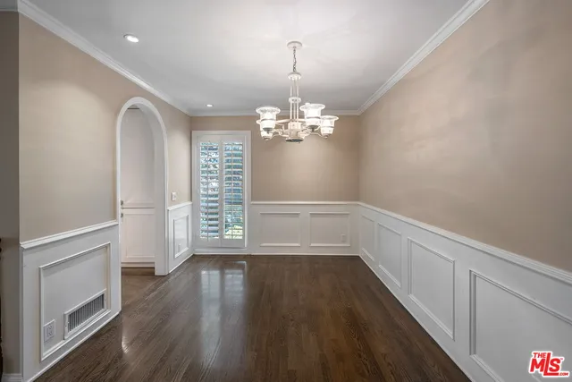 a view of a room with wooden floor and large windows