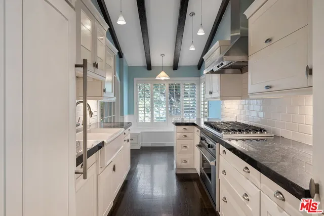 a kitchen with granite countertop a stove and a sink