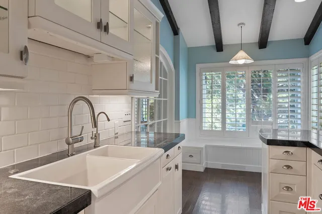 a dining room with furniture a flat screen tv and a large window