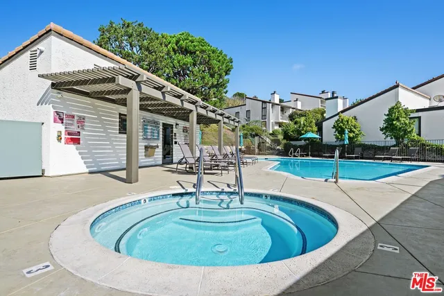 a view of a tennis ground with large trees
