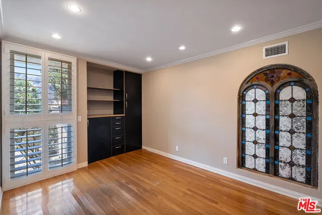 a bedroom with a bed and a painting on the wall