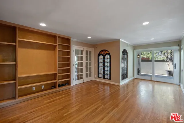 a spacious bedroom with a large bed and a flat screen tv
