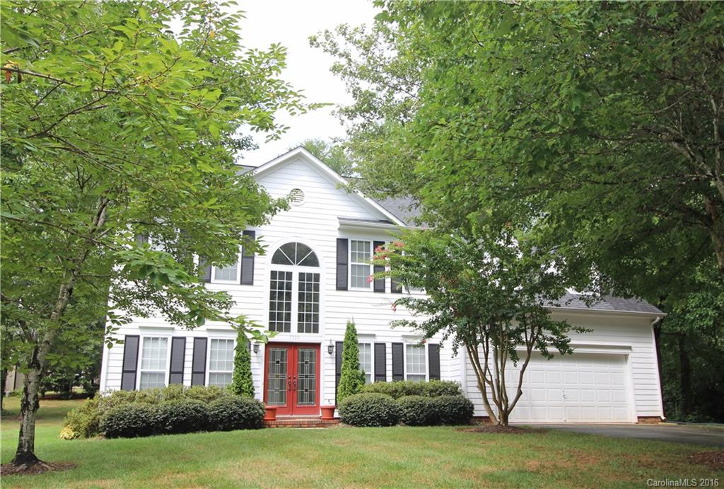 7300 Reedy Creek Road, Unit 59 Charlotte, NC 28215 - Photo 1 of 24 a front view of a house with a yard and garage