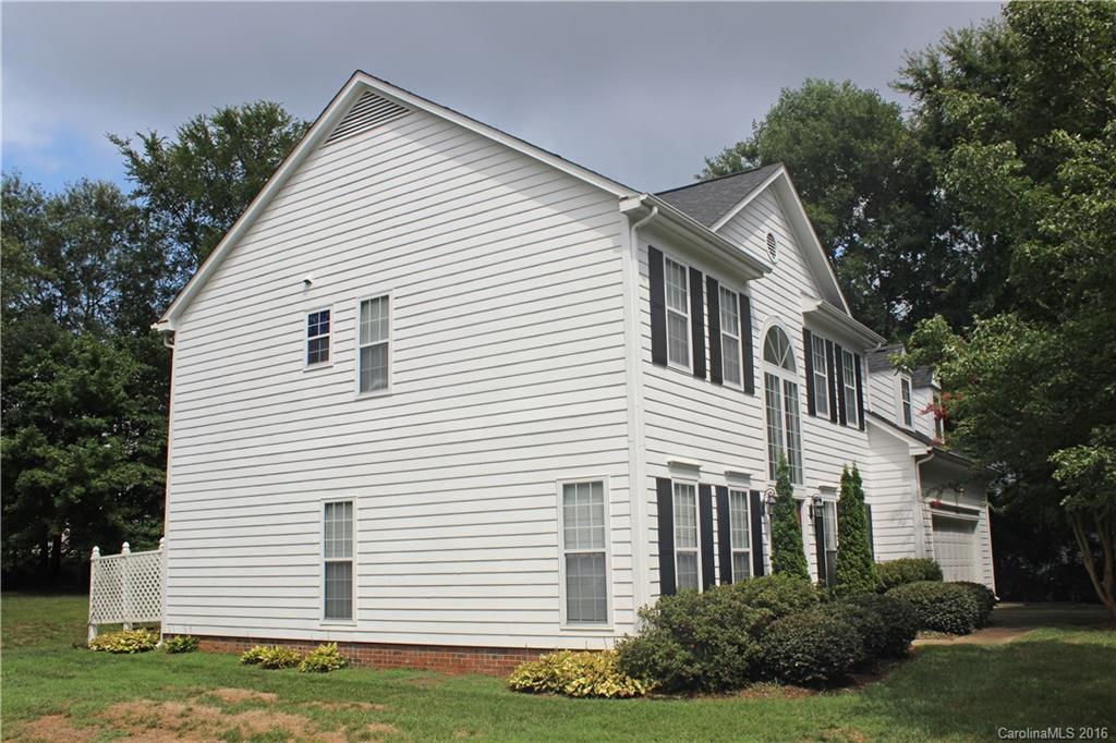 7300 Reedy Creek Road, Unit 59 Charlotte, NC 28215 - Photo 2 of 24 a view of a white house next to a yard