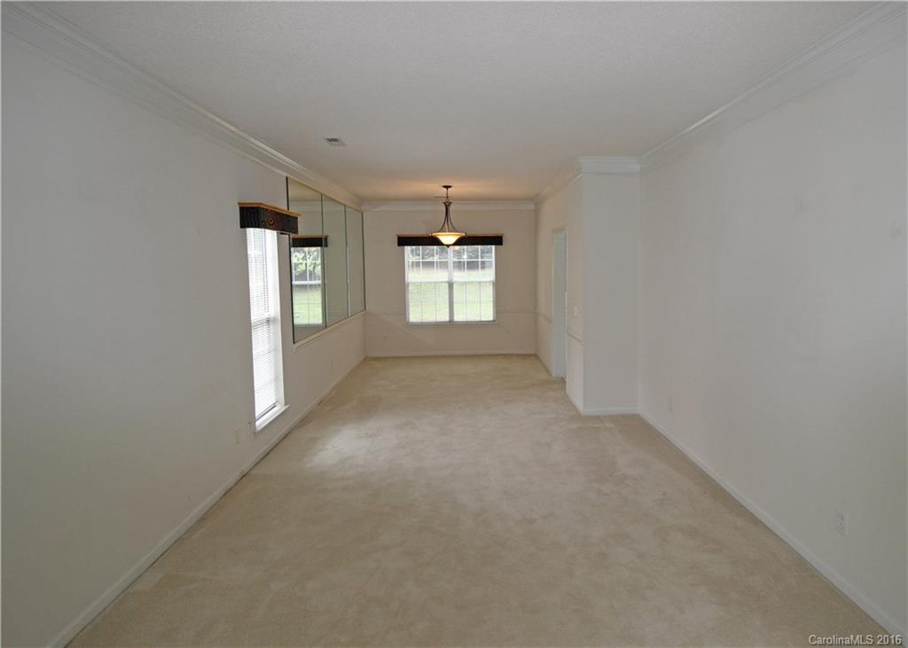 7300 Reedy Creek Road, Unit 59 Charlotte, NC 28215 - Photo 11 of 24 wooden floor in an empty room with a window