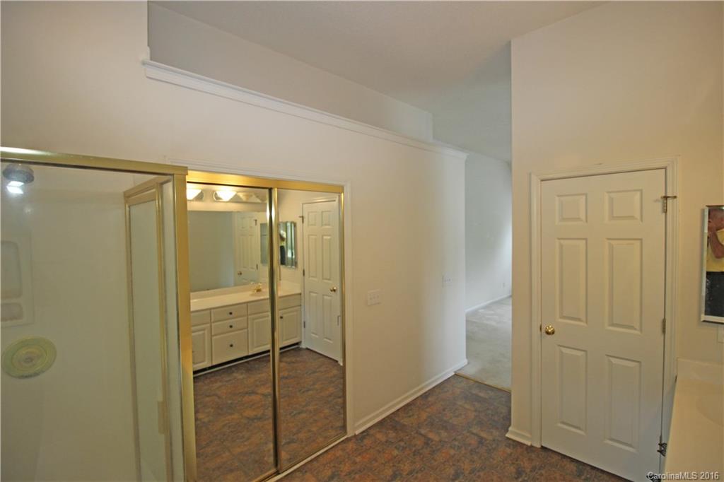 7300 Reedy Creek Road, Unit 59 Charlotte, NC 28215 - Photo 19 of 24 a bathroom with a glass shower door