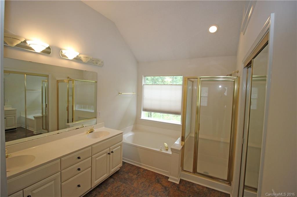 7300 Reedy Creek Road, Unit 59 Charlotte, NC 28215 - Photo 20 of 24 a bathroom with a double vanity sink and mirror with shower