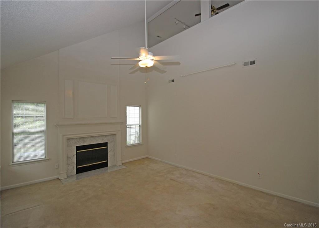 7300 Reedy Creek Road, Unit 59 Charlotte, NC 28215 - Photo 5 of 24 an empty room with windows and fireplace
