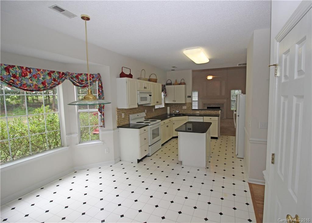 7300 Reedy Creek Road, Unit 59 Charlotte, NC 28215 - Photo 8 of 24 a kitchen with a sink a stove a refrigerator and a window