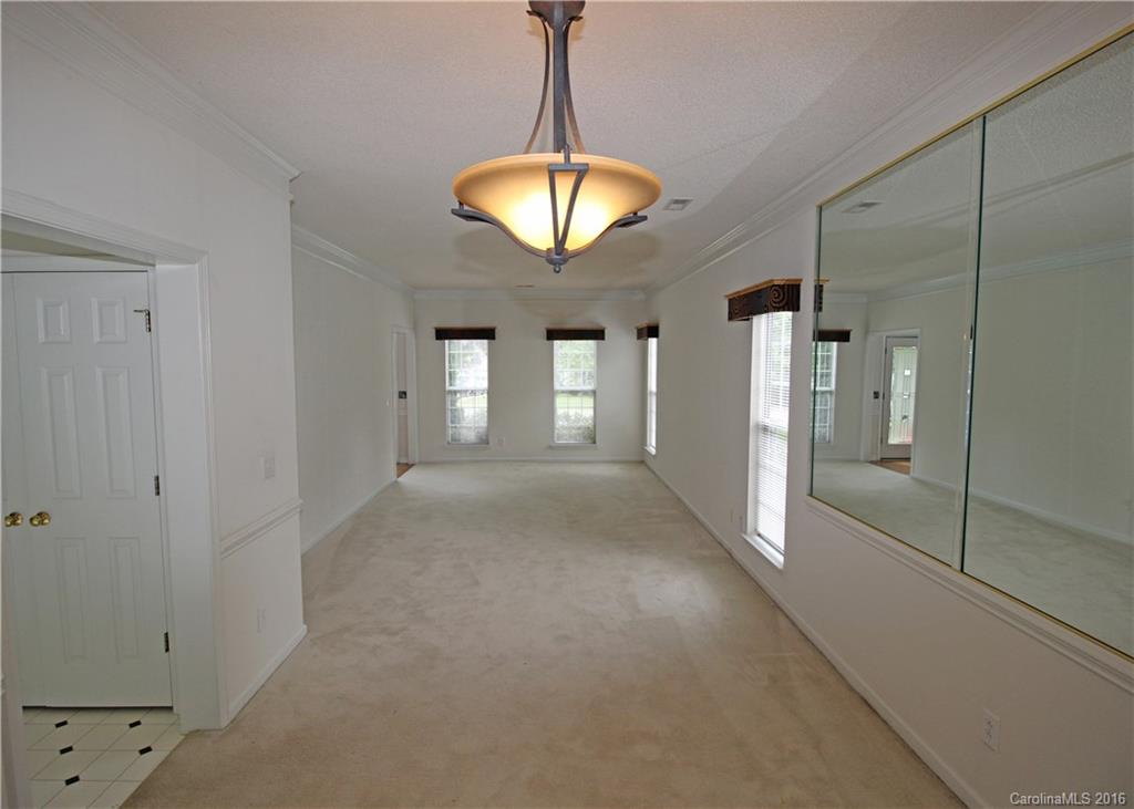 7300 Reedy Creek Road, Unit 59 Charlotte, NC 28215 - Photo 10 of 24 a view of a hallway with windows and chandelier