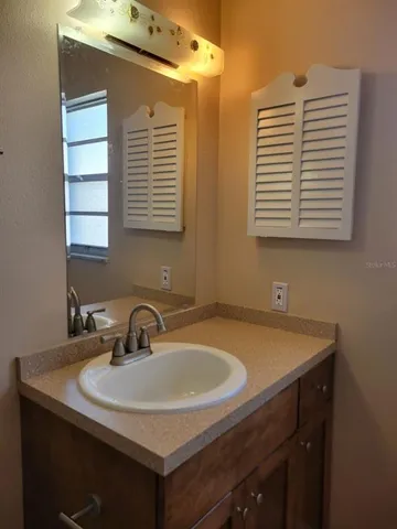 a bathroom with a sink and a window