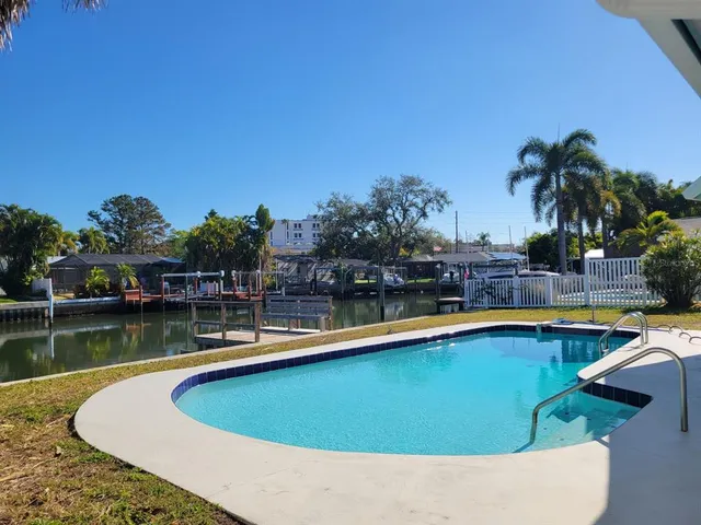 a view of a swimming pool with a lounge chair