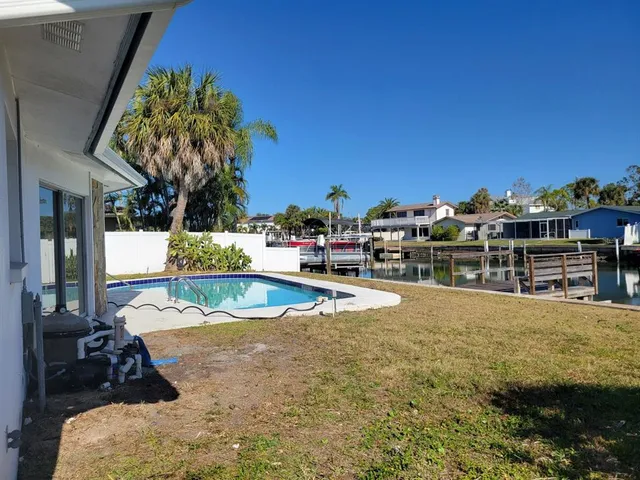 a view of a swimming pool with an outdoor seating and a garden