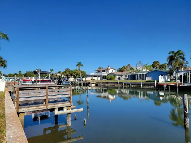 a view of a lake with chairs