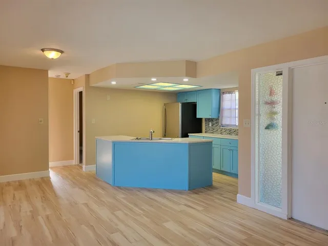 a kitchen with stainless steel appliances kitchen island wooden floors and granite counter tops