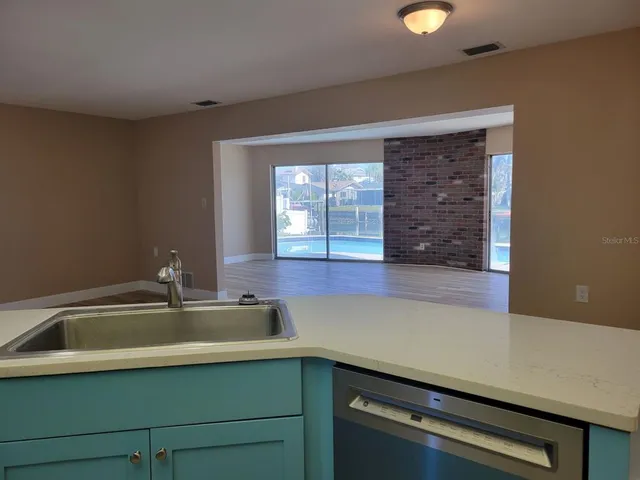 a kitchen with a sink and cabinets