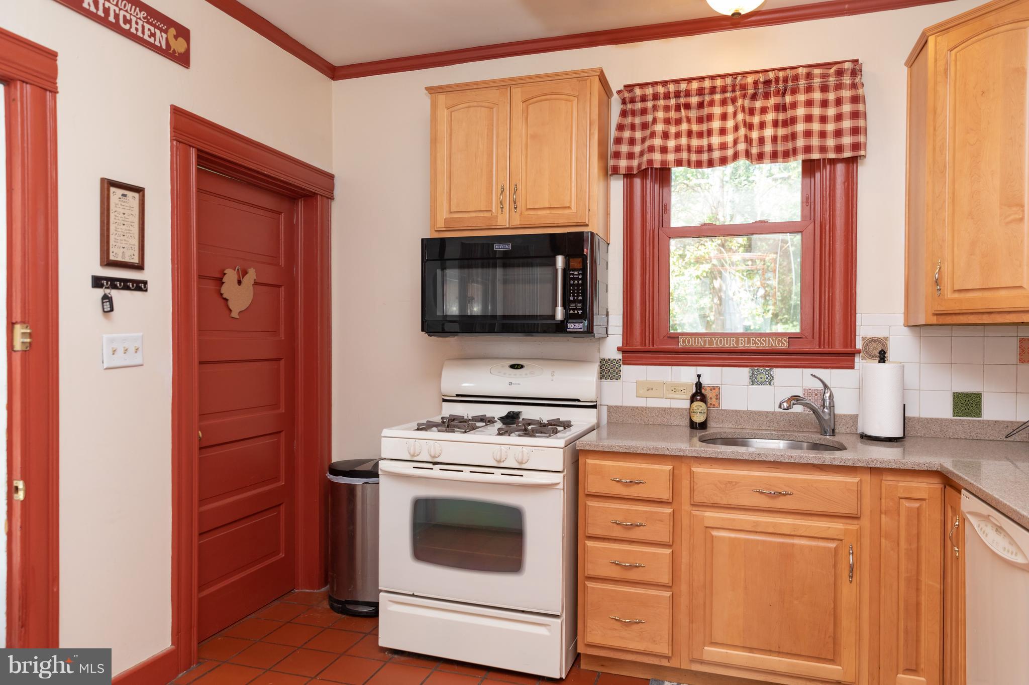 302 South Hammonds Ferry Road Linthicum Heights, MD 21090 - Photo 14 of 29 a kitchen with stainless steel appliances white cabinets and a sink