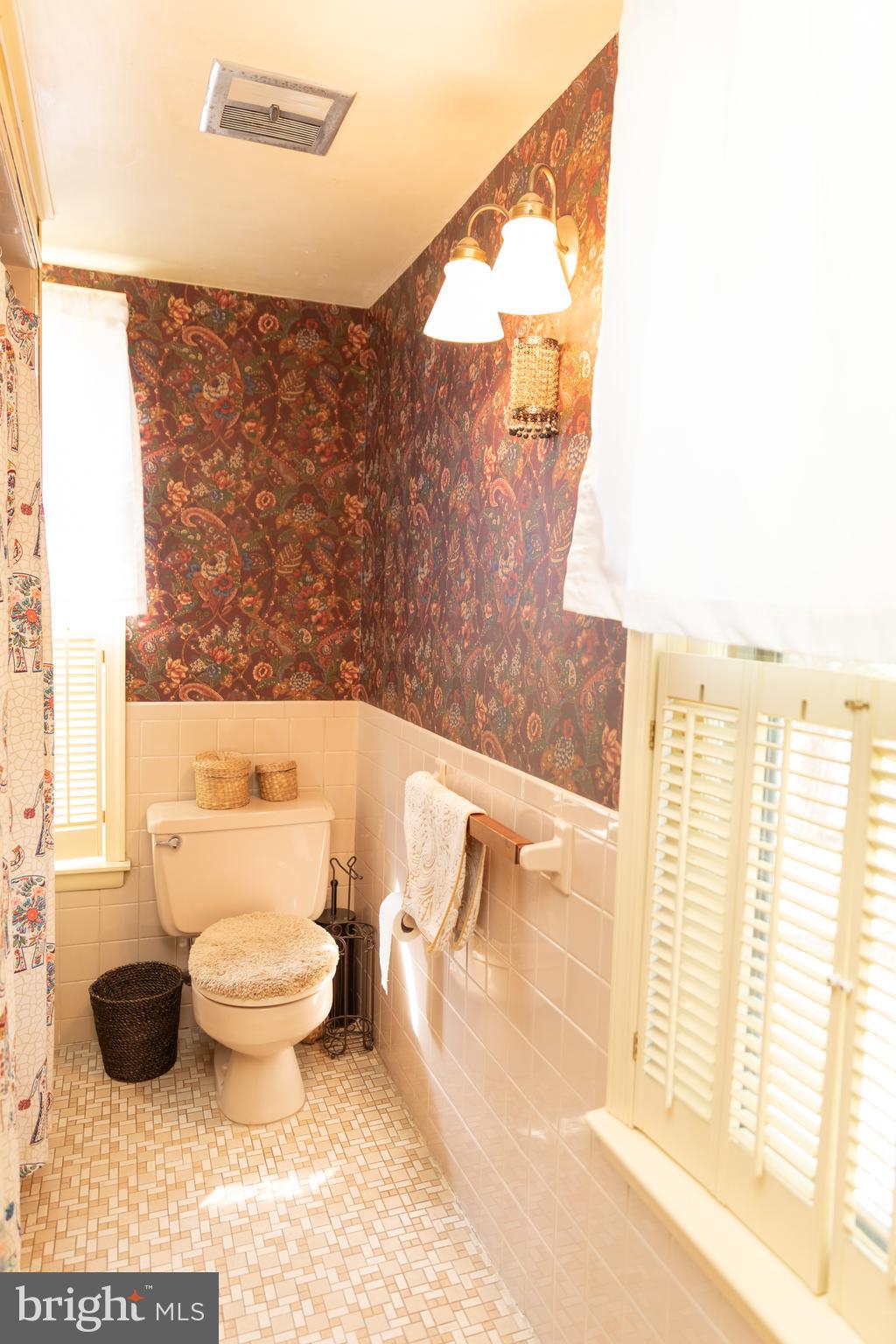 302 South Hammonds Ferry Road Linthicum Heights, MD 21090 - Photo 21 of 29 a bathroom with a toilet and a shower curtain