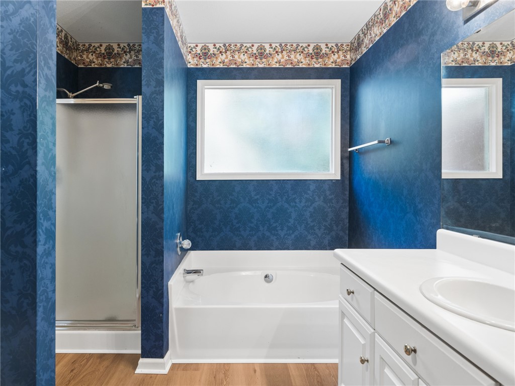 101 Woodbridge Circle Anderson, SC 29621 - Photo 9 of 21 This bathroom features a shower, tub, and a vanity, offering both function and comfort.