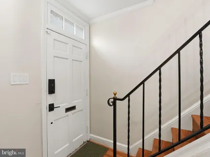a view of staircase with lots of frames on wall