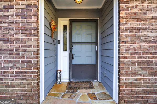 a kitchen with granite countertop a sink cabinets stainless steel appliances and a window