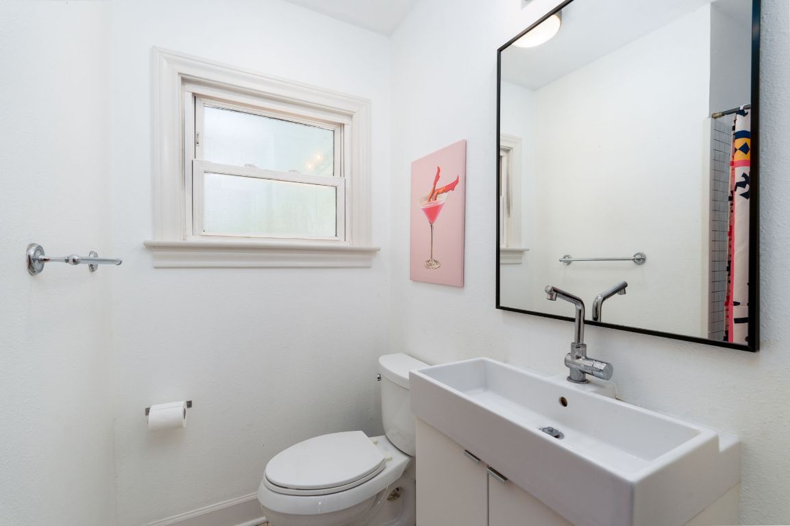 746 Springdale Road Austin, TX 78702 - Photo 13 of 20 a bathroom with a toilet sink and mirror