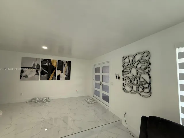 a kitchen with stainless steel appliances granite countertop a sink and a white cabinets