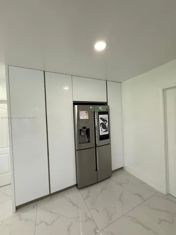 a bedroom with bed and glass door