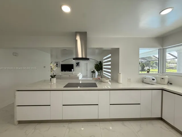 a kitchen with a sink a stove and refrigerator