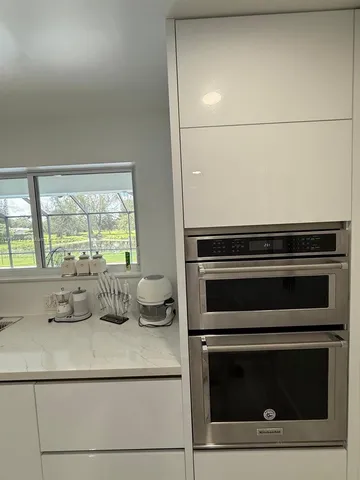 a bathroom with a sink toilet mirror and vanity