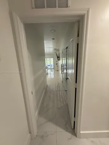 a view of a dining room with furniture and window