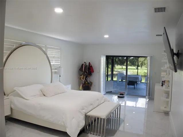 a view of a livingroom with furniture and a floor to ceiling window