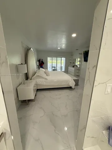 a living room with couch and a floor to ceiling window