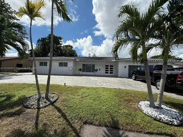 a backyard of a house with large trees