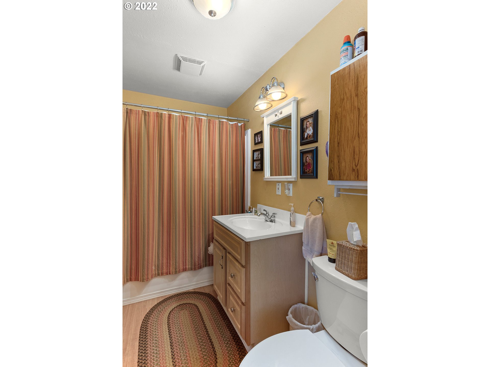 45 Buck Lane Goldendale, WA 98620 - Photo 17 of 32 a bathroom with a toilet sink vanity and mirror