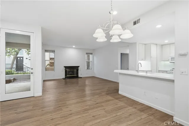 a view of a kitchen with a sink a kitchen microwave and cabinets