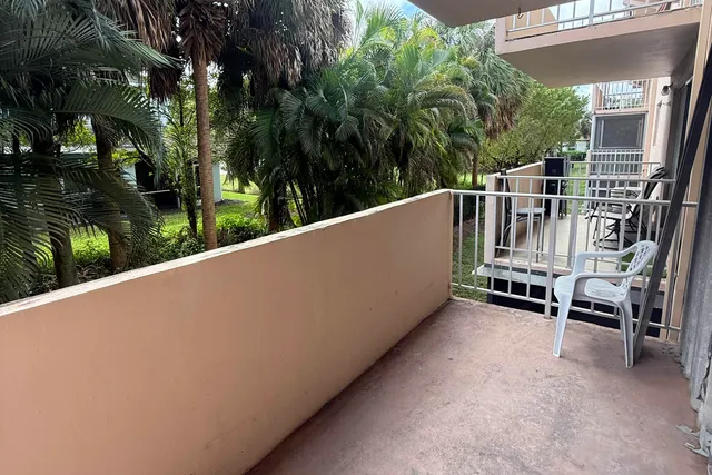 a view of balcony with furniture