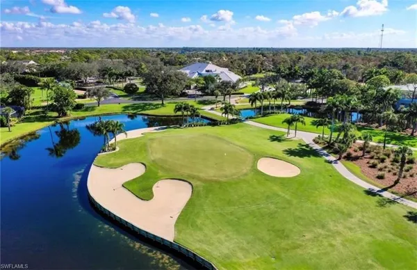 a view of a swimming pool with a yard and outdoor seating
