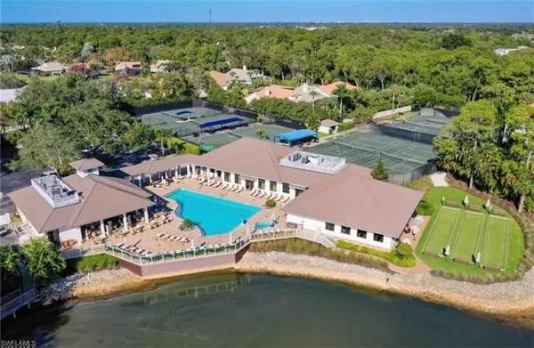 an aerial view of a house with a garden and lake view