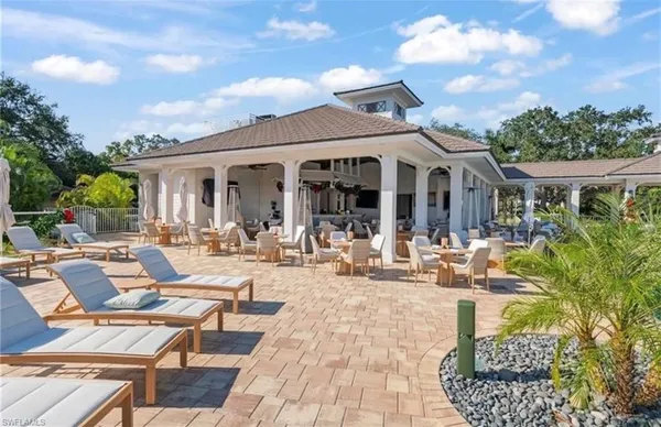 a view of a patio with couches table and chairs and potted plants