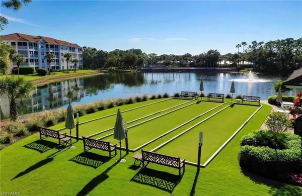 a view of a lake with couches and wooden floor