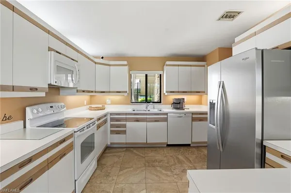 a kitchen with a sink stove and refrigerator