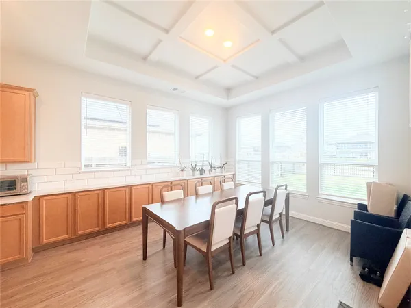 a view of a dining room with furniture and windows